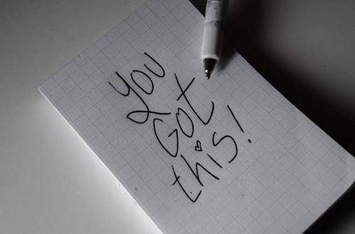 Inspirational handwritten note on graph paper with pen. Encouraging words 'You got this!'